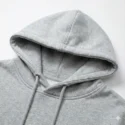 Macro shot of double-lined hood stitching and neckline durability on grey oversized sweatshirt.
